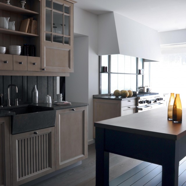 A charming kitchen featuring a top-of-the-line Wolf kitchen range - 1