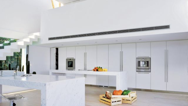 Immaculate white lacquer kitchen with Carrera marble countertops