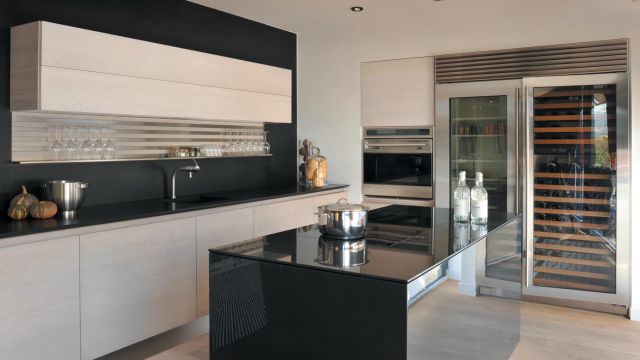 Ultra-modern carbon fiber paired with unfinished oak in this stunning luxury kitchen