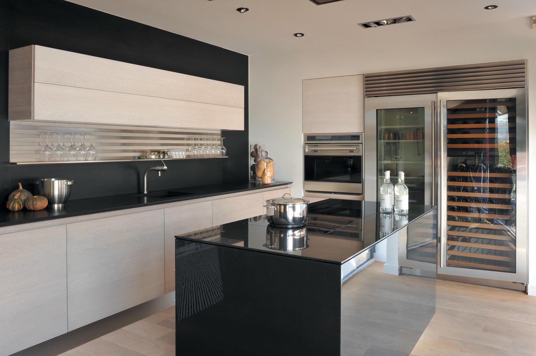 Ultra-modern carbon fiber paired with unfinished oak in this stunning luxury kitchen