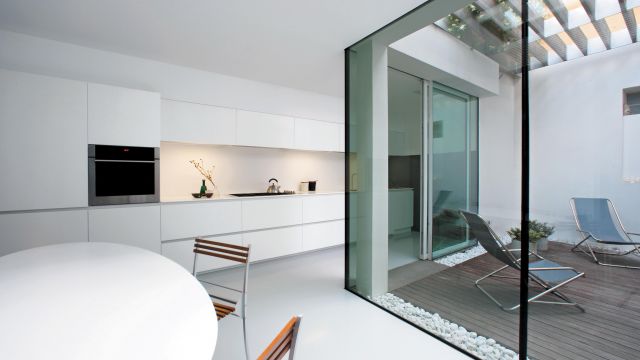 Super sleek lacquered kitchen featuring well-balanced and light-filled design